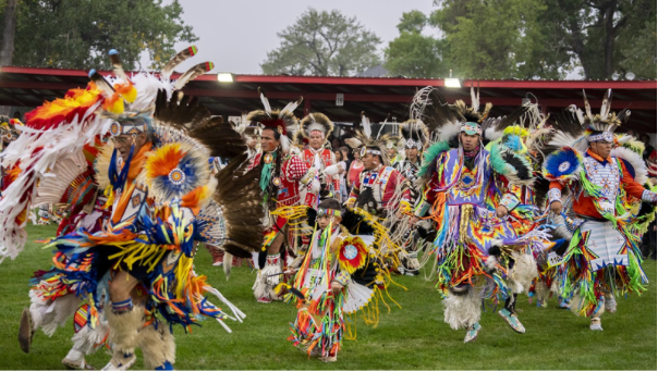 Powwow Dancers celebrating Indigenous Peoples’ Day in a dancing parade (Photo: The North Dakota)